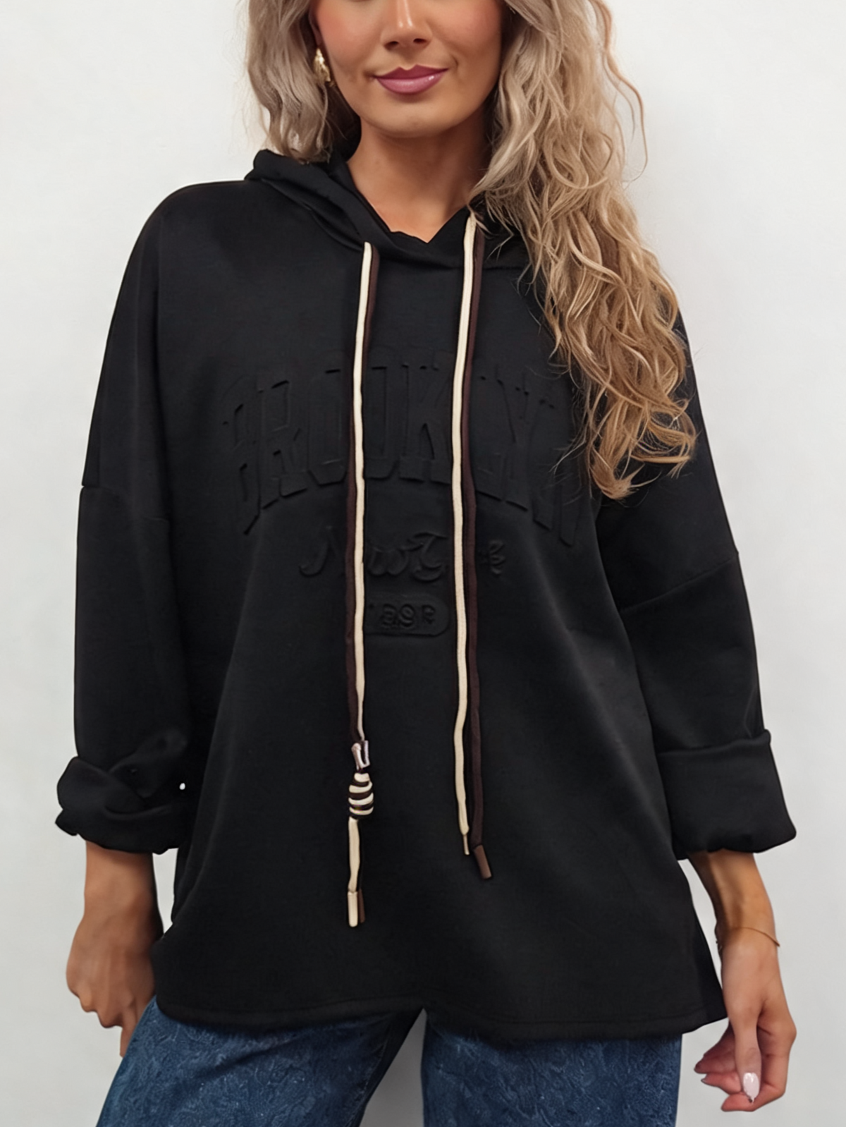 Oversized hooded sweatshirt in black with contrast drawstrings and embossed front logo