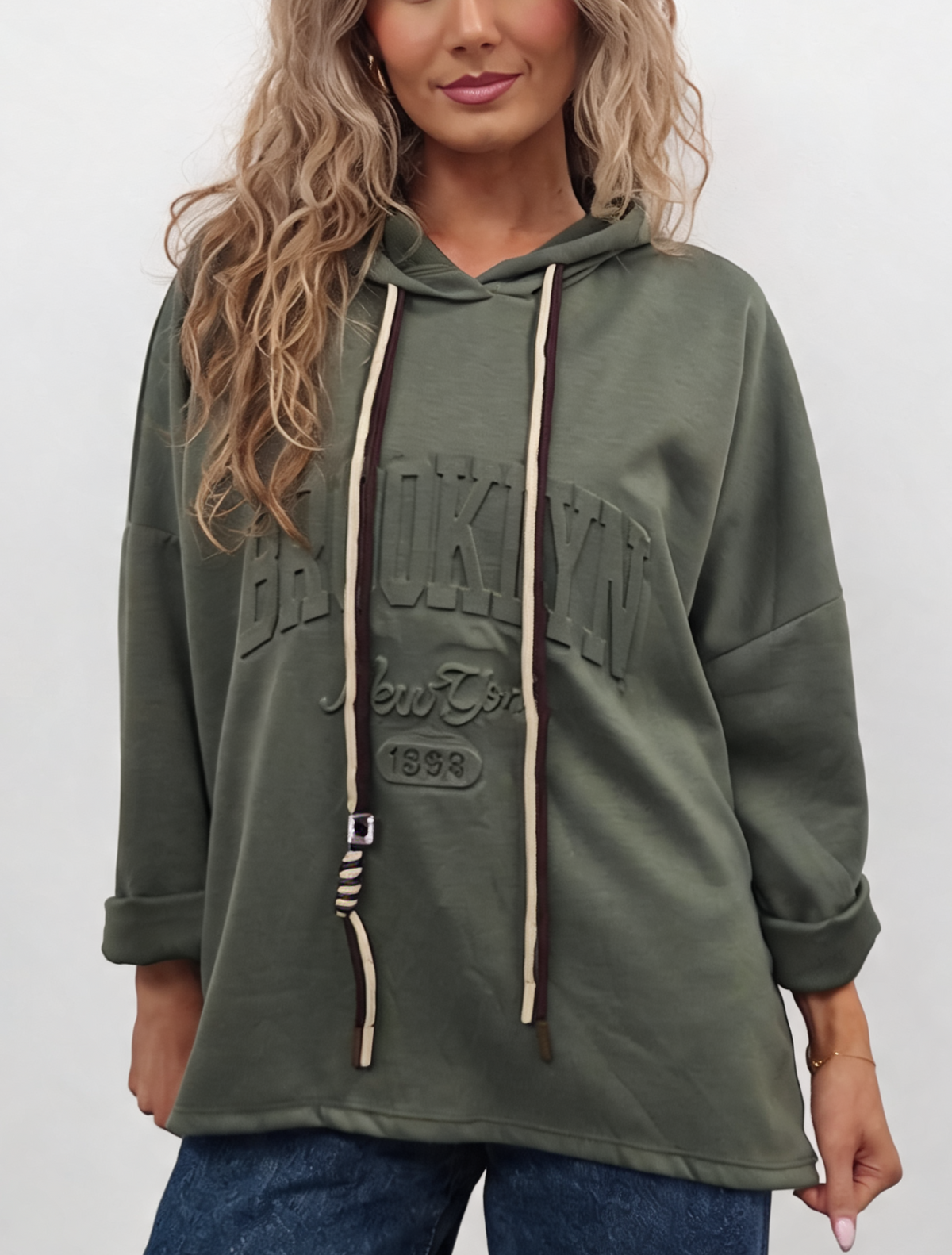 Oversized hooded sweatshirt in olive green with contrast drawstrings and embossed front logo