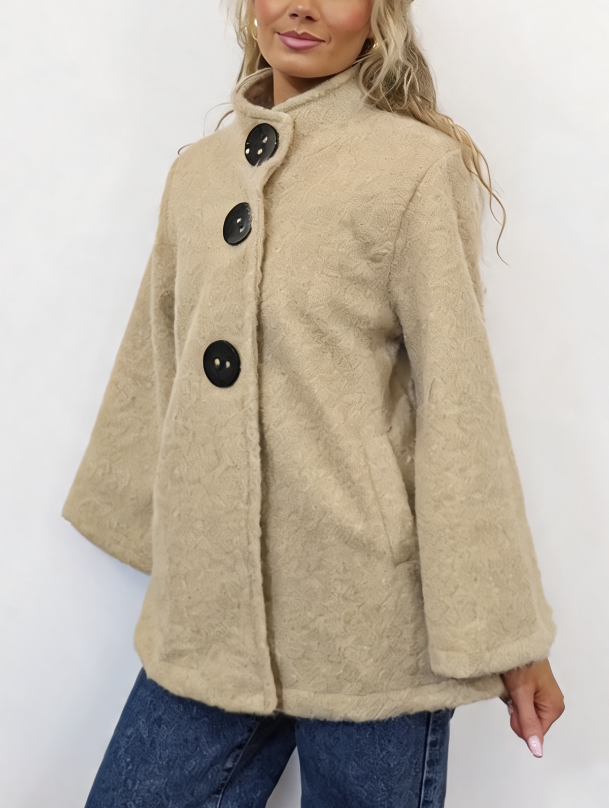 Beige textured teddy swing coat with funnel neck, snap buttons, and roomy sleeves