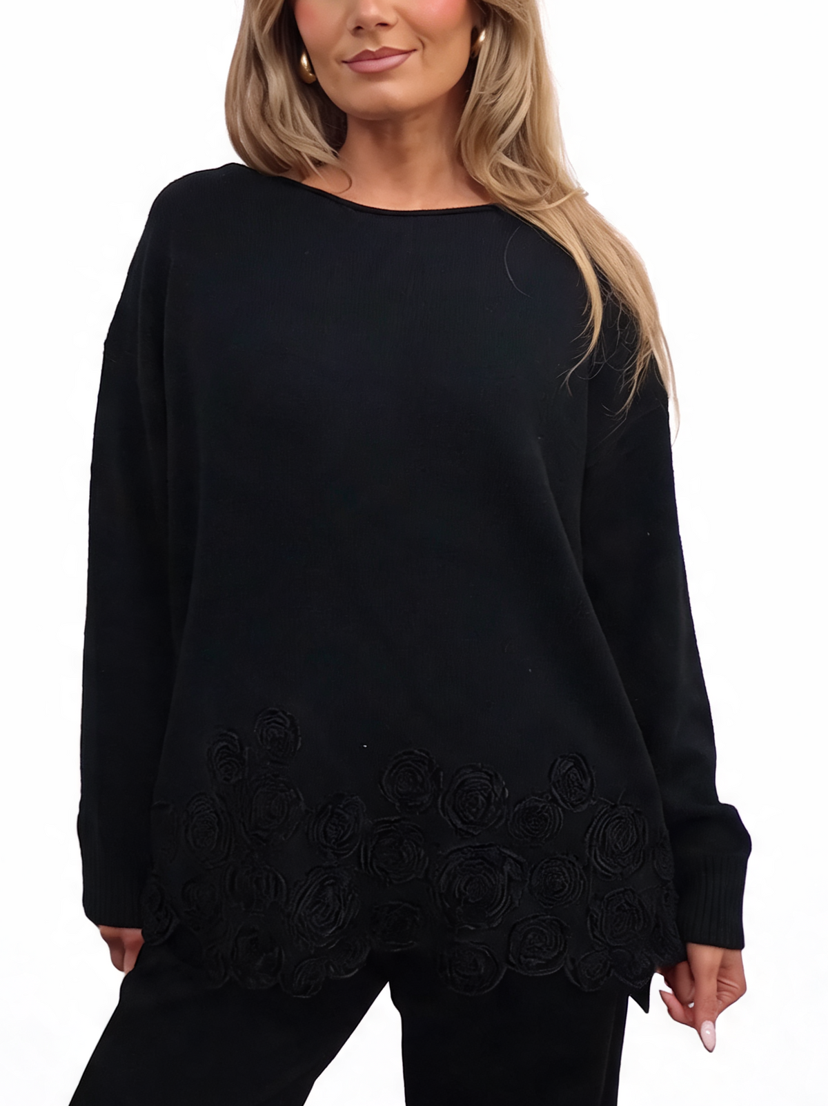 Black oversized chenille knit top with long sleeves and floral hem detail