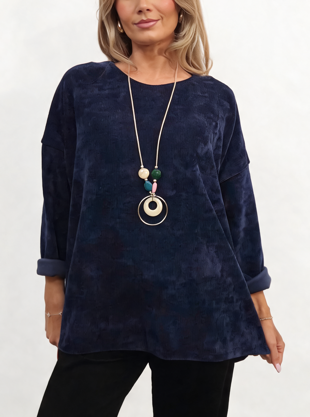 Navy oversized chenille knit top with rolled cuffs and a beaded pendant necklace