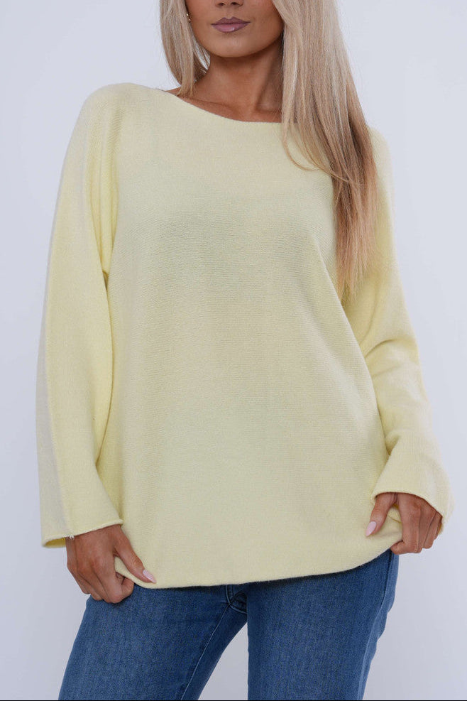 Pale yellow boat neck knit sweater with long sleeves and relaxed curved hem